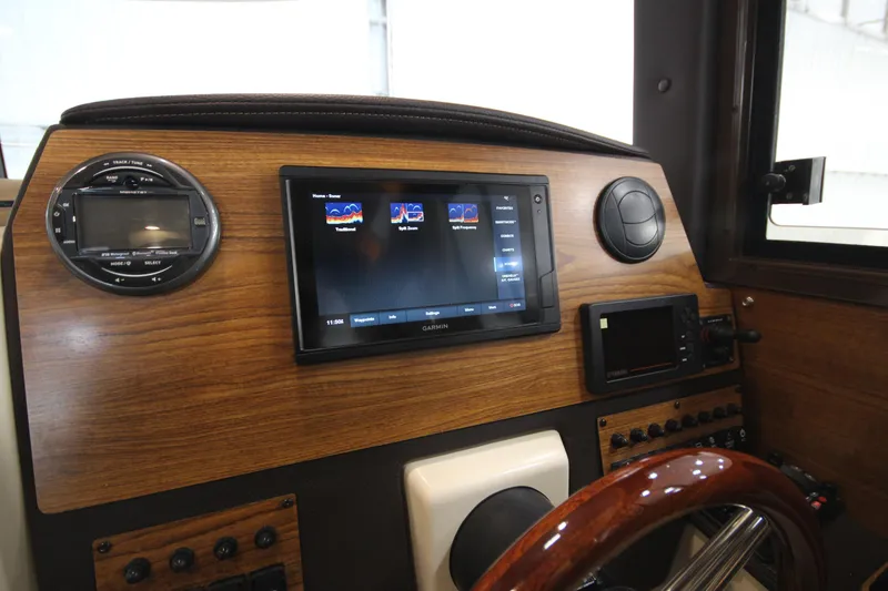 Slide: The Image of 2025 Ranger Tugs R-23 dashboard with modern navigation and control systems. - 46