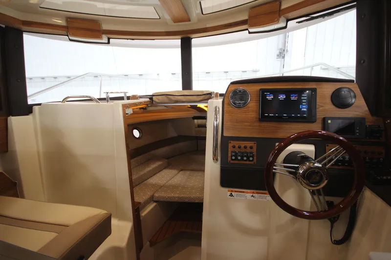 Slide: The Image of Interior of 2025 Ranger Tugs R-23 boat with modern helm and cozy cabin. - 48