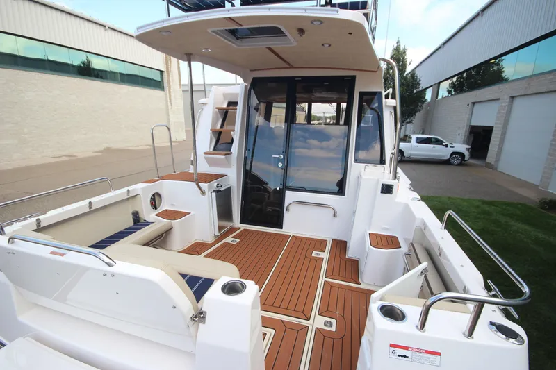 Slide: The Image of 2025 Ranger Tugs R-29 Command Bridge Luxury Edition with teak deck and modern design. - 11