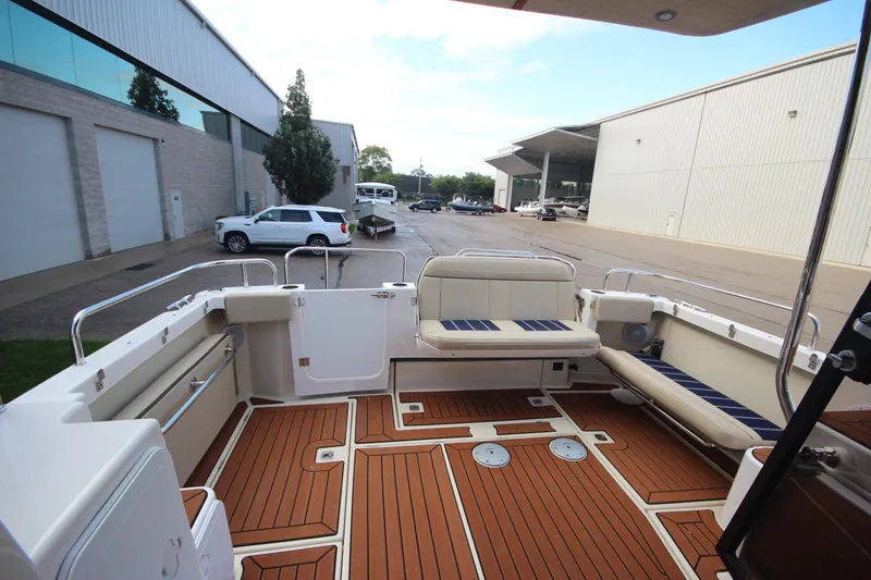 Slide: The Image of 2025 Ranger Tugs R-29 Command Bridge Luxury Edition boat deck with seating and wood flooring. - 12