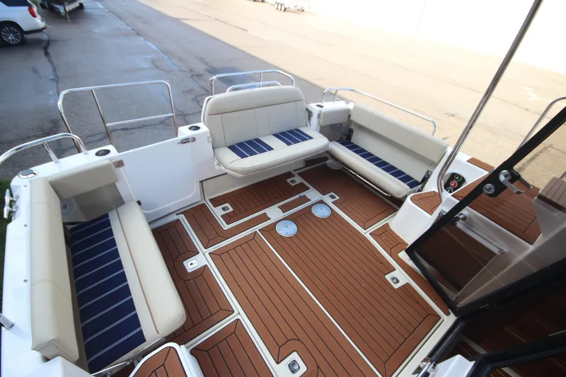 Slide: The Image of 2025 Ranger Tugs R-29 Command Bridge Luxury Edition with elegant seating and teak-style flooring. - 14