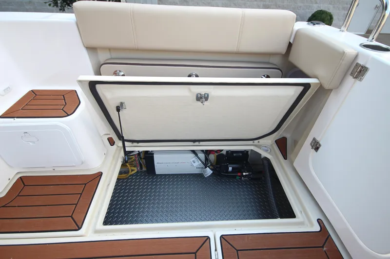 Slide: The Image of 2025 Ranger Tugs R-29 Command Bridge Luxury Edition storage compartment with teak flooring. - 16
