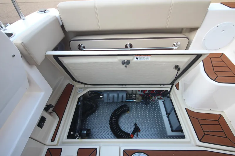 Slide: The Image of 2025 Ranger Tugs R-29 Command Bridge Luxury Edition storage compartment with open hatch. - 17