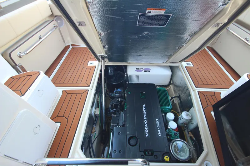 Slide: The Image of Engine compartment of 2025 Ranger Tugs R-29 Command Bridge Luxury Edition with Volvo Penta engine. - 18