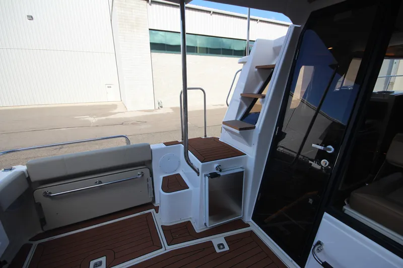 Slide: The Image of 2025 Ranger Tugs R-29 Command Bridge Luxury Edition, featuring elegant deck and staircase design. - 21