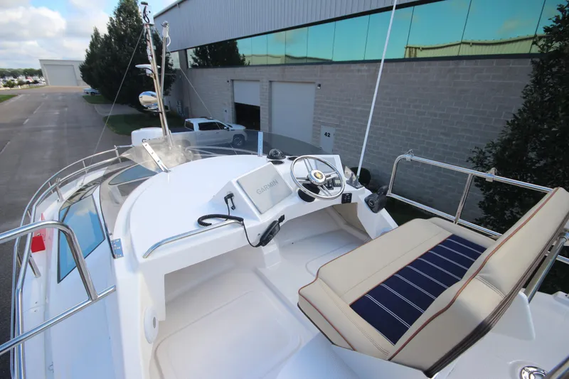 Slide: The Image of 2025 Ranger Tugs R-29 Command Bridge Luxury Edition helm with Garmin navigation system. - 22