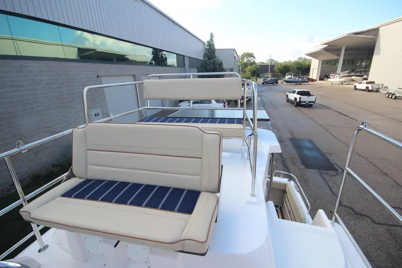 Slide: The Image of 2025 Ranger Tugs R-29 Command Bridge Luxury Edition with elegant seating on deck. - 23