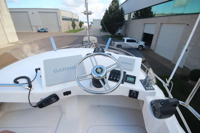 Slide: The Image of 2025 Ranger Tugs R-29 Command Bridge Luxury Edition helm with Garmin navigation system. - 24