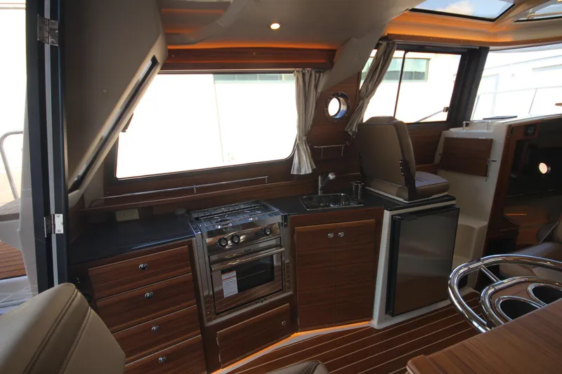 Slide: The Image of Luxurious interior of 2025 Ranger Tugs R-29 Command Bridge, featuring modern kitchen amenities. - 28