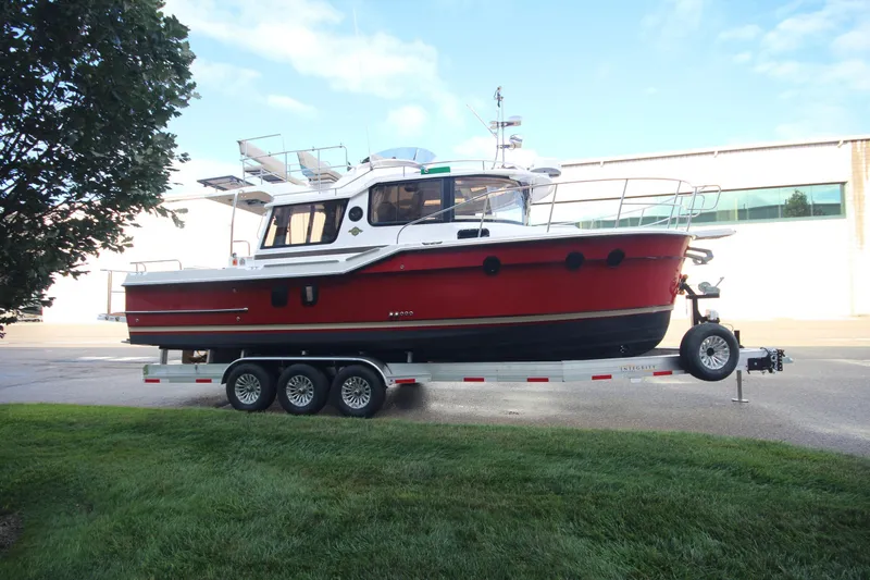 Slide: The Image of 2025 Ranger Tugs R-29 Command Bridge Luxury Edition on trailer, parked outdoors. - 3
