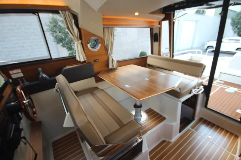Slide: The Image of 2025 Ranger Tugs R-29 Command Bridge Luxury Edition interior with elegant wood finishes. - 31
