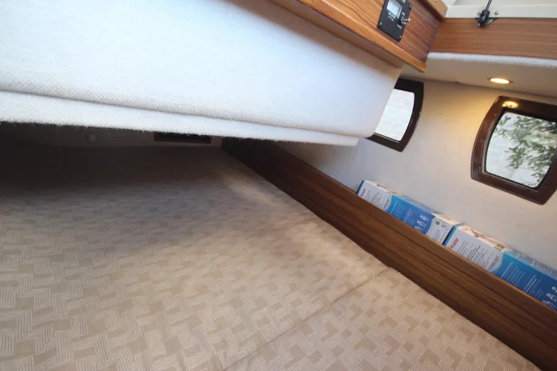 Slide: The Image of 2025 Ranger Tugs R-29 Command Bridge Luxury Edition interior cabin with cozy bedding. - 35