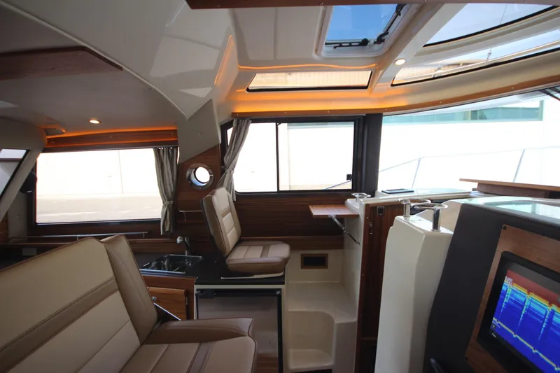 Slide: The Image of Interior of 2025 Ranger Tugs R-29 Command Bridge Luxury Edition, featuring modern design and seating. - 37