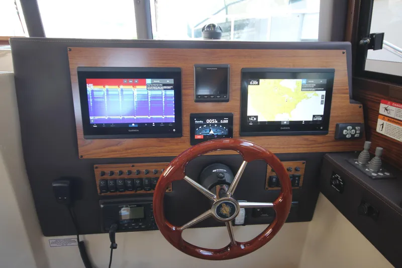 Slide: The Image of 2025 Ranger Tugs R-29 Command Bridge helm with advanced navigation displays. - 40