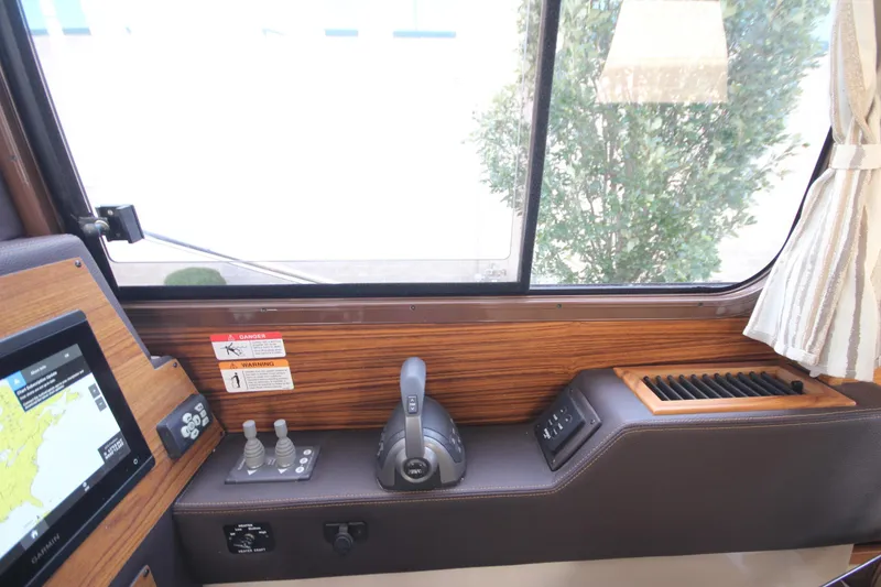 Slide: The Image of 2025 Ranger Tugs R-29 Command Bridge helm with navigation controls and window view. - 41