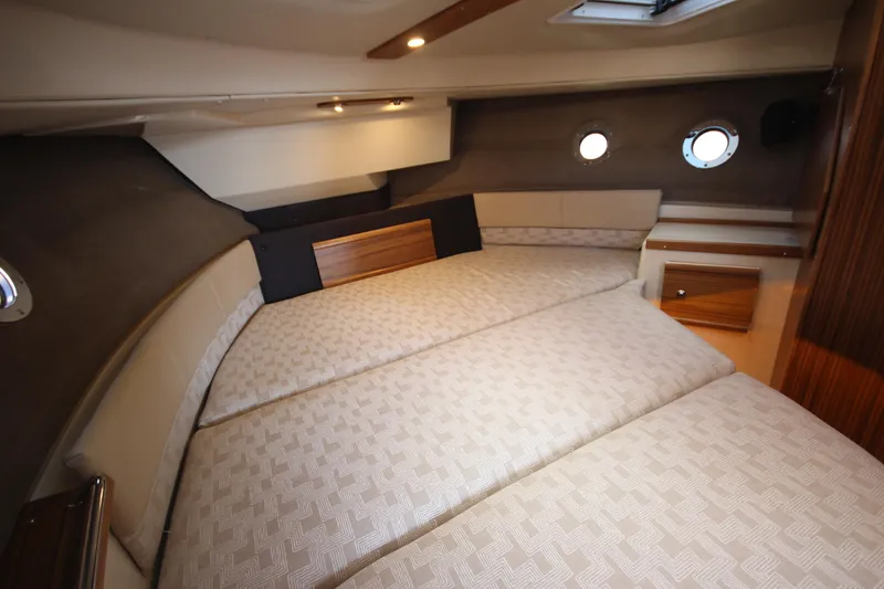 Slide: The Image of Luxurious cabin interior of 2025 Ranger Tugs R-29 Command Bridge, featuring elegant bedding and wood accents. - 44