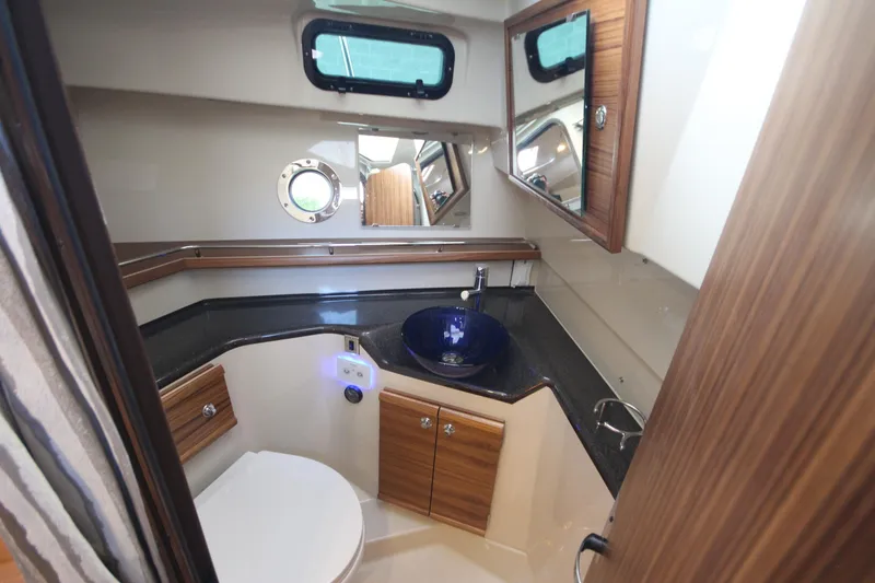 Slide: The Image of Luxurious bathroom in 2025 Ranger Tugs R-29 Command Bridge yacht, featuring modern fixtures and wood accents. - 47