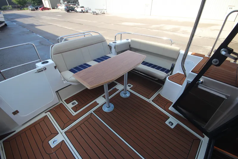 Slide: The Image of 2025 Ranger Tugs R-29 Command Bridge Luxury Edition deck with seating and table. - 51