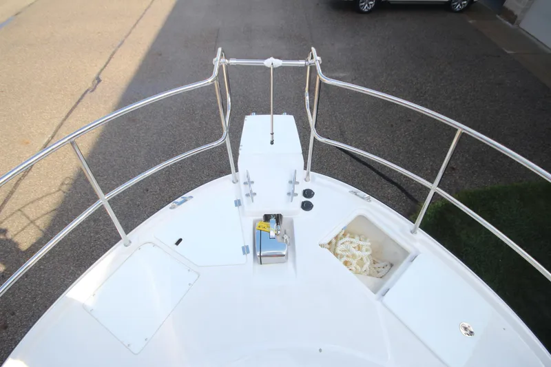Slide: The Image of Bow of 2025 Ranger Tugs R-29 Command Bridge, featuring stainless steel railings and anchor storage. - 53