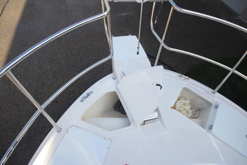 Slide: The Image of Bow deck of 2025 Ranger Tugs R-29 Command Bridge, featuring storage compartments and railing. - 54
