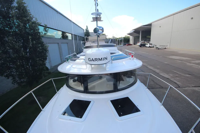 Slide: The Image of 2025 Ranger Tugs R-29 Command Bridge Luxury Edition docked, featuring Garmin navigation. - 56