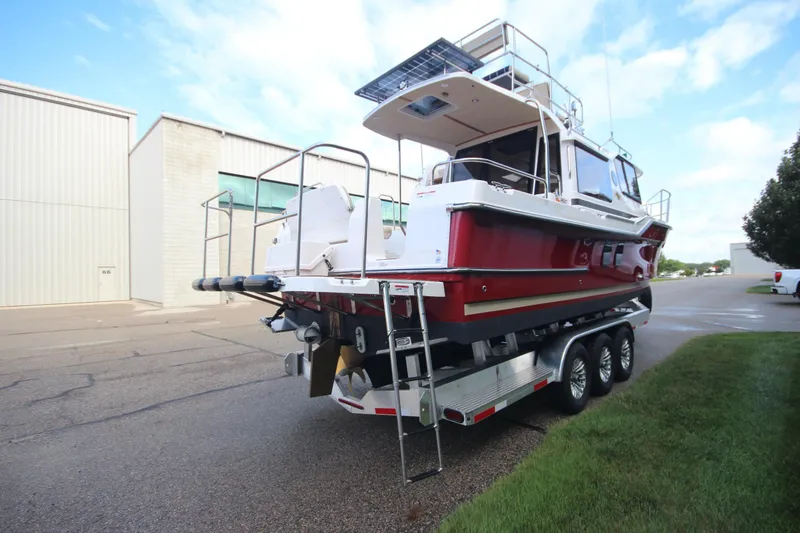 Slide: The Image of 2025 Ranger Tugs R-29 Command Bridge Luxury Edition on trailer, parked outdoors. - 7
