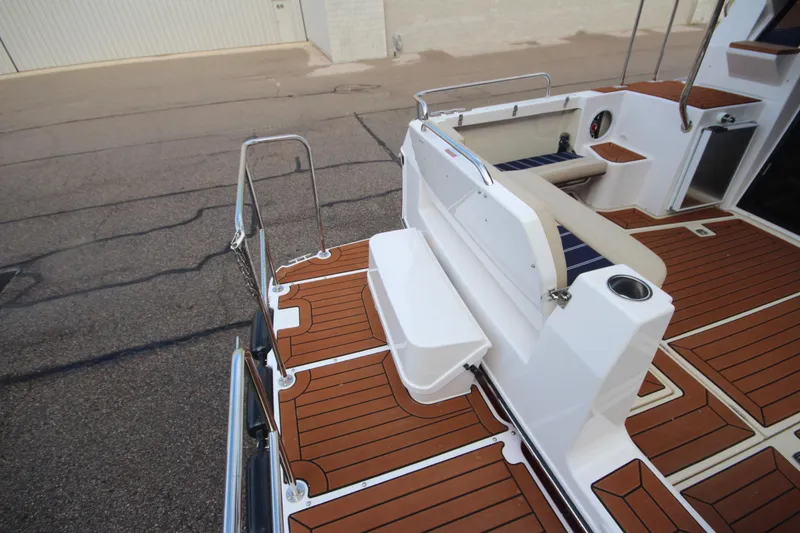 Slide: The Image of 2025 Ranger Tugs R-29 Command Bridge Luxury Edition deck with seating and wood finish. - 8