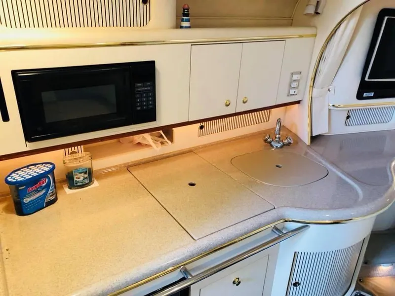 Slide: The Image of 2000 Sea Ray Sundancer 310 kitchen with microwave and sink. - 12