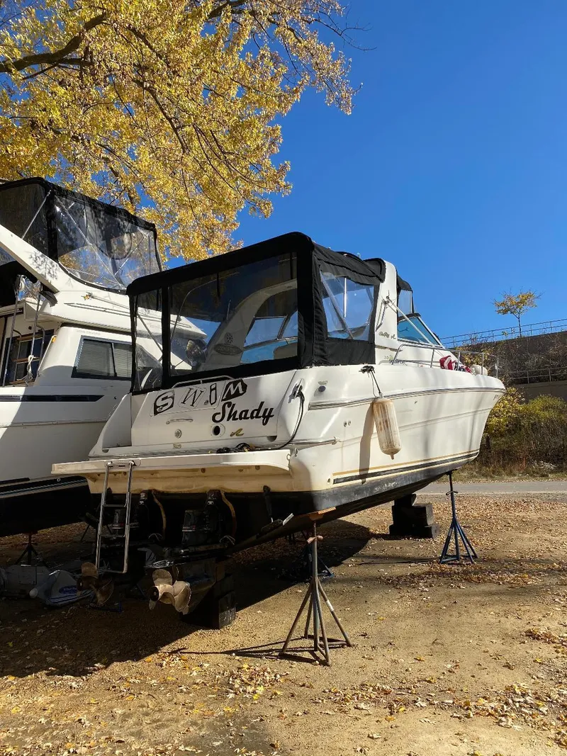 Slide: The Image of 2000 Sea Ray Sundancer 310 boat on stands outdoors. - 16