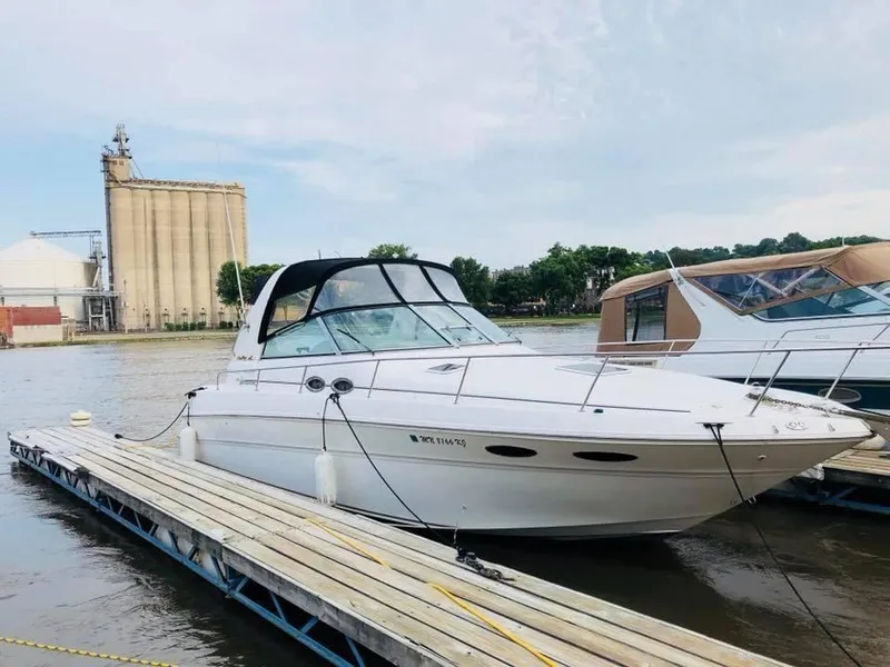 Slide: The Image of 2000 Sea Ray Sundancer 310 docked, serene water setting. - 4