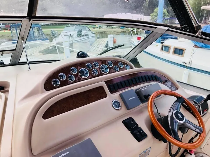 Slide: The Image of 2000 Sea Ray Sundancer 310 dashboard with gauges and steering wheel. - 6