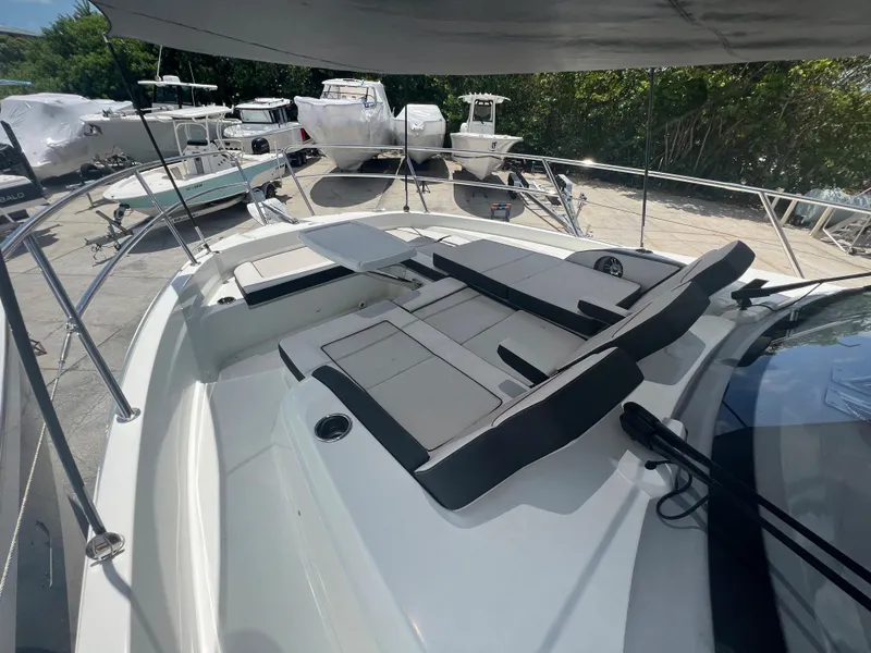 Slide: The Image of 2024 Jeanneau Leader 12.5 boat with spacious deck and comfortable seating. - 12