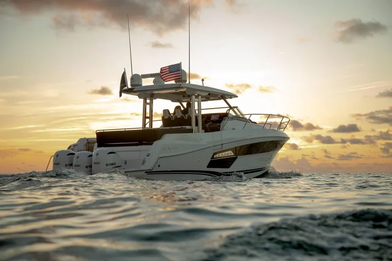 Slide: The Image of 2024 Jeanneau Leader 12.5 boat cruising at sunset. - 18