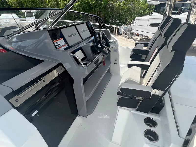 Slide: The Image of 2024 Jeanneau Leader 12.5 cockpit with modern navigation system and comfortable seating. - 7