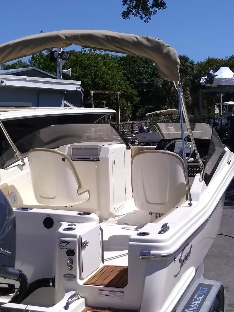 Slide: The Image of Scout 215 Dorado 2026 boat with bimini top in harbor. - 7