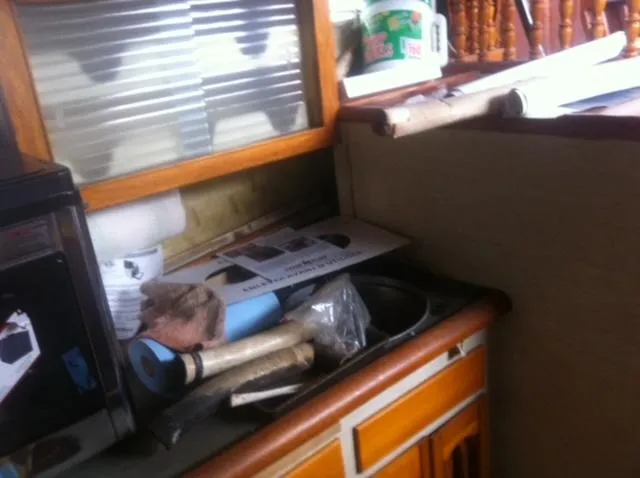 Slide: The Image of 1952 Chris-Craft Buccaneer interior with wooden cabinetry and various items on the counter. - 11