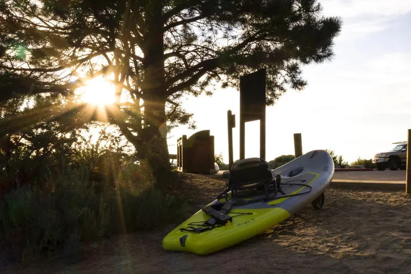 Slide: The Image of Hobie iTrek 9 Ultralight 2023 kayak on sandy beach at sunset. - 10