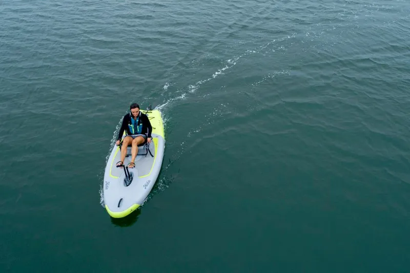 Slide: The Image of Person riding a 2023 Hobie iTrek 9 Ultralight on calm water. - 12
