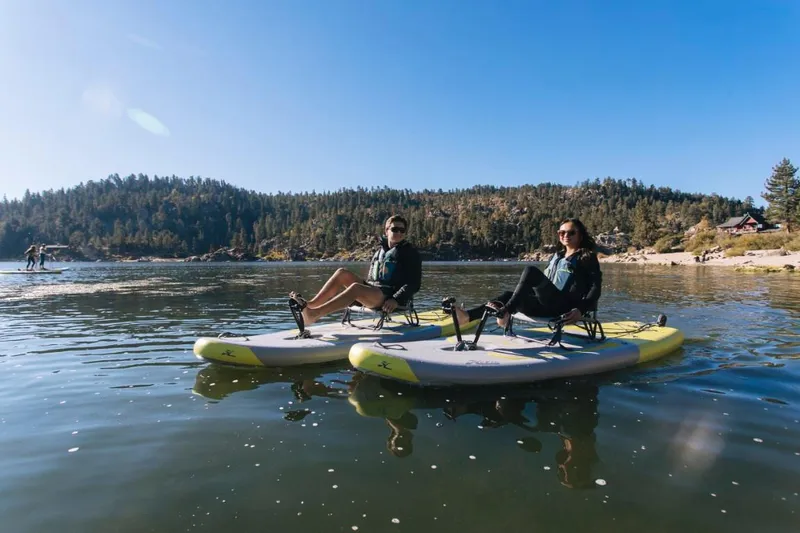 Slide: The Image of Two people relaxing on Hobie iTrek 9 Ultralight kayaks, 2025 model, on a serene lake. - 4