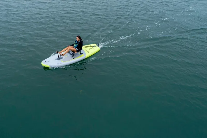 Slide: The Image of Person kayaking on a 2023 Hobie iTrek 9 Ultralight in calm waters. - 11