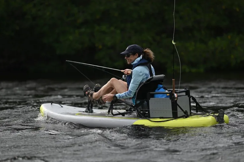Slide: The Image of Person fishing on a 2023 Hobie iTrek 9 Ultralight inflatable kayak. - 2