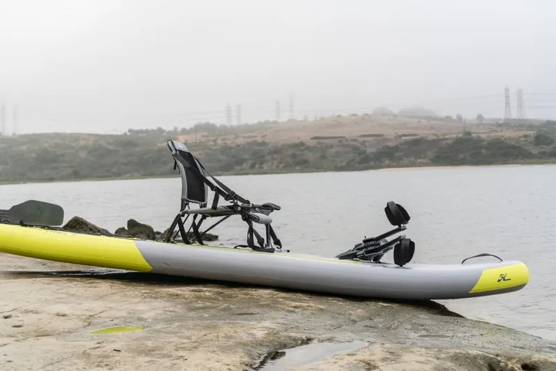 Slide: The Image of Hobie iTrek 9 Ultralight 2023 inflatable kayak on a lakeside rock. - 5