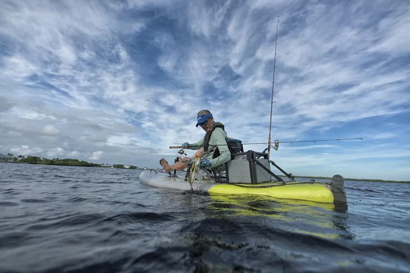 Slide: The Image of Person fishing on a 2023 Hobie iTrek 9 Ultralight kayak in open water. - 6