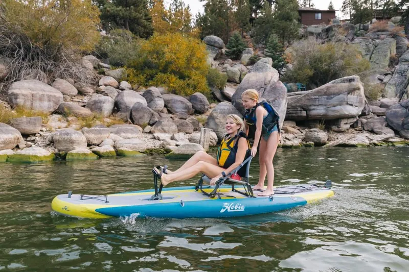 The Image of Two people enjoying a ride on a 2023 Hobie ITREK 11 inflatable kayak. - 0