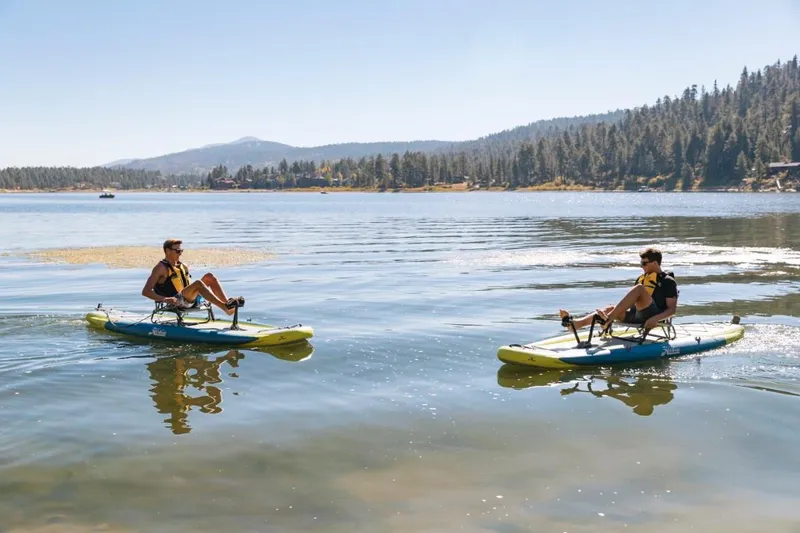 Slide: The Image of Two people kayaking on a lake with 2023 Hobie ITREK 11 models. - 10