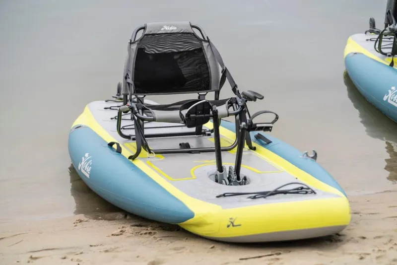 Slide: The Image of 2023 Hobie ITREK 11 inflatable kayak with pedal drive system on a sandy shore. - 4