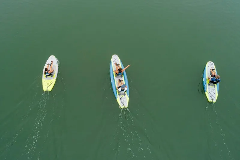 Slide: The Image of Aerial view of three Hobie iTrek 14 Duo kayaks on calm water, 2023 model. - 5