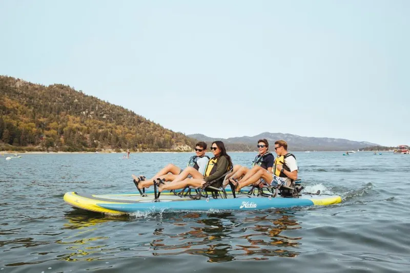 Slide: The Image of Four people enjoying a ride on a 2023 Hobie iTrek Fiesta pedal kayak. - 1