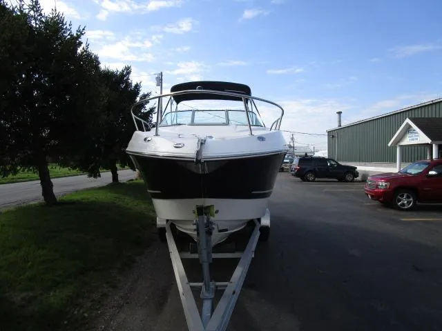 The Image of 2010 Chaparral 270 Signature boat on trailer in parking lot. - 1