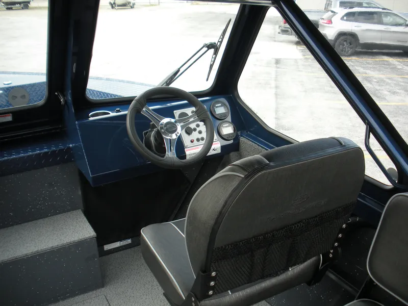 Slide: The Image of 2024 Duckworth 18 Advantage Sport boat interior, featuring steering wheel and dashboard controls. - 10